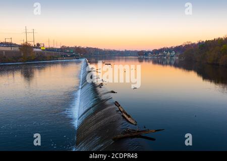 Philadelphia, Pennsylvania, USA dam on the Schuylkill River with Boathouse Row in the distance at dawn. Stock Photo