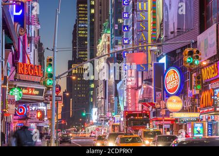 NEW YORK CITY - NOVEMBER 14, 2016: Traffic moves below the illuminated signs of 42nd Street. The landmark street is home to numerous theaters, stores, Stock Photo
