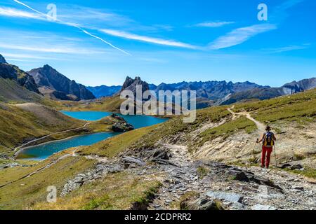 Trekking on alpine paths, between lakes of rare beauty and pristine peaks Stock Photo
