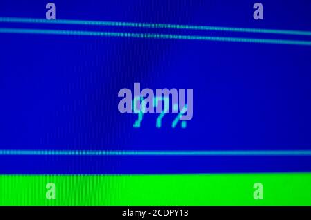 laptop with 97% loading bar on a blue screen. Setting the loading indicator concept Stock Photo