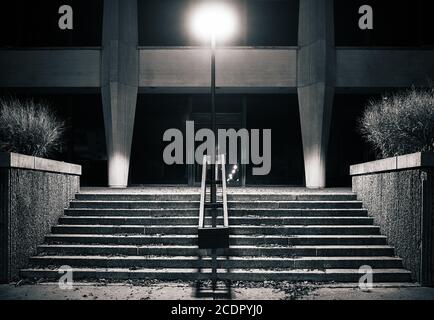 Stairs at night lighted by a single spooky light Stock Photo