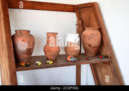 Shelves with standing on their utensils of porcelain and earthenware. Vintage kitchen utensils Stock Photo