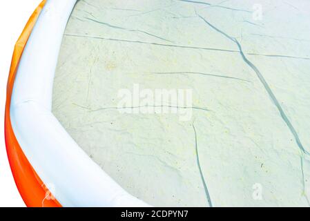 Mildew stains in an unclean domestic pool, dirty and blooming water unsuitable for bathing, isolated on white background. Stock Photo