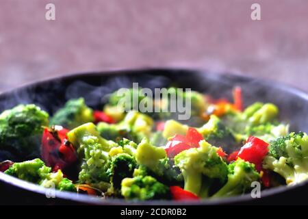 vegetables in a pan standing on the stove, vegetable stew, healthy vegan food, closeup Stock Photo