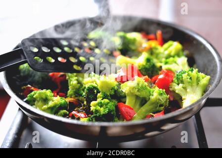 vegetables in a pan standing on the stove, vegetable stew, healthy vegan food, closeup Stock Photo