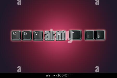 Computer keyboard keys spelling Covid-19, isolated on a dark background Stock Photo