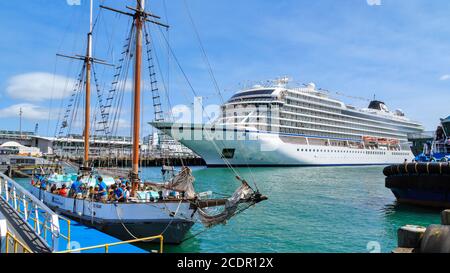A traditional sailing ship, the 'Ted Ashby', and a modern cruise liner, the 'Viking Orion' in Auckland Harbour, Auckland, New Zealand, January 27 2019 Stock Photo