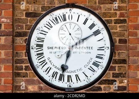 The Shepherd Gate Clock is mounted on the wall outside the gate of the Royal Greenwich Observatory in London. It is unusual as it has a twenty four ho Stock Photo