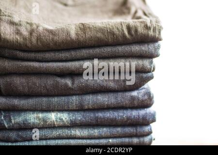 Stack of jeans on white background Stock Photo