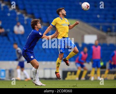 Brighton and Hove Albion's Adam Lallana (right) and Chelsea's Marcos Alonso battle for the ball during the pre-season friendly at the AMEX Stadium in Brighton where up to 2500 fans have been allowed in to watch the match after the Government announced a further batch of sporting events that will be used to pilot the safe return of spectators. Stock Photo