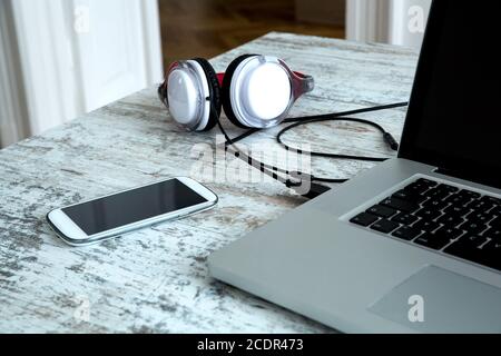Headphones and a Laptop computer on a Desktop Stock Photo