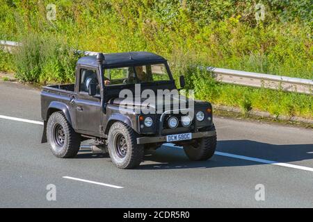 1965 60s Land Rover 88' - 4 CYL pick up; Vehicular traffic moving vehicles, cars driving a vehicle on UK roads, motors, motoring on the M6 motorway highway network. Stock Photo