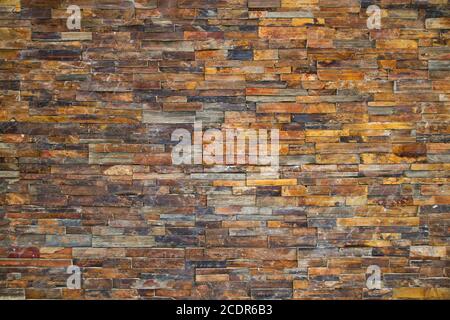 slate rock wall made with colorful smooth pieces Stock Photo