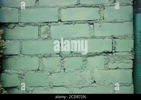 Painted into military green Brick wall background closeup Stock Photo