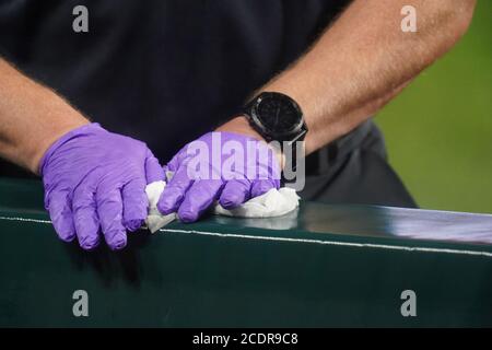 St. Louis, USA. 29th August, 2020. A Cleveland Indians trainer wipes down the top of the padding in the dugout before a game against the St. Louis Cardinals at Busch Stadium in St. Louis on Friday, August 28, 2020. Photo by Bill Greenblatt/UPI Credit: UPI/Alamy Live News Stock Photo