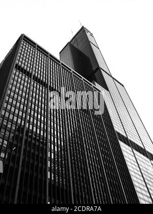 Looking up at Willis Tower / Sears Tower in Chicago, USA from ground level. Looming black skyscraper designed by Fazlur Rahman Khan. Stock Photo