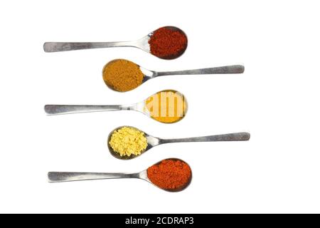 Various seasoning spices on metal spoons Stock Photo