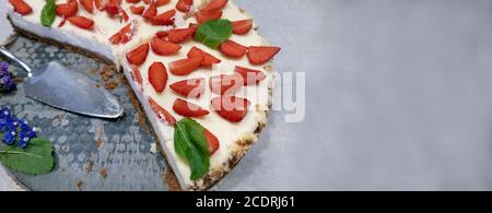 Slice of homemade cheesecake with strawberries and mint. Copy space Stock Photo