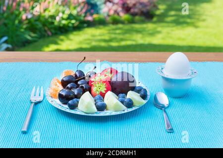 Fruit plate on table outside in garden Stock Photo