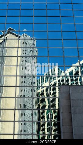 Downtown buildings are reflected in the windows of a skyscrapper in Nashville, Tennessee USA. Stock Photo