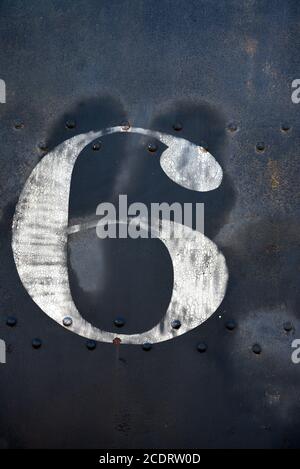 The number 6 painted on the side of a vintage railroad steam locomotive on display in Madrid, New Mexico USA. Stock Photo