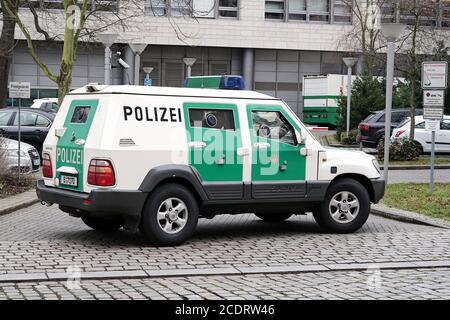 Armored police car as escort   for a money transport in the inner city of Magdeburg Stock Photo