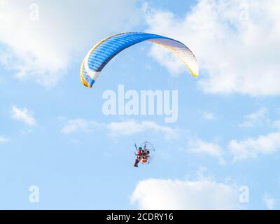 A man practicing extreme sport with paraglider with motor Stock Photo