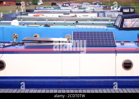 Solar panels on roof of canal narrow boat providing off grid power Stock Photo