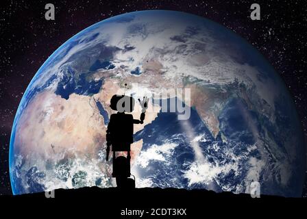 Robot looking on the planet Earth from space. Technology concept, artificial intelligence Stock Photo