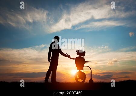 Man and robot meet and handshake. Concept of the future interaction with artificial intelligence Stock Photo