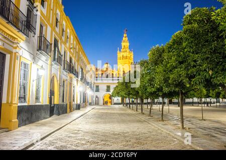 The Giralda bell tower lit up at night in Seville, Spain, Europe Stock Photo