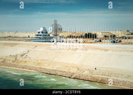 Section of the new Suez expansion canal with the Suez Canal monument Stock Photo