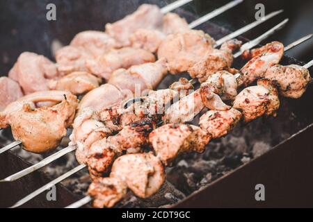 Barbecue roasted pieces of meat on metall skewers Stock Photo