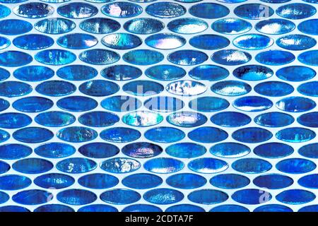 Pattern and texture in blue and white shades from small, oval, slightly shining tile ornaments Stock Photo