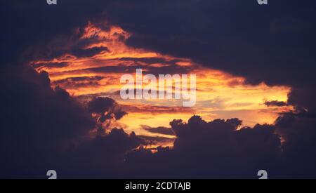 Hole in the sky, spectacular purple and orange sunset. Stock Photo