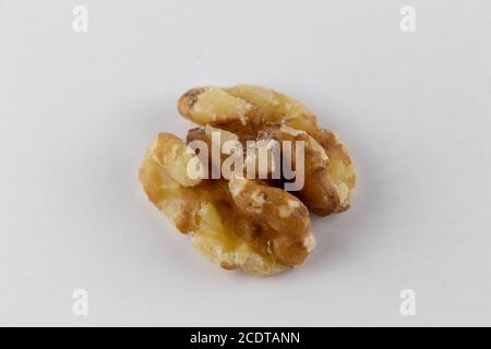 macro shot of a single walnut half on a white background with slight drop shadow Stock Photo