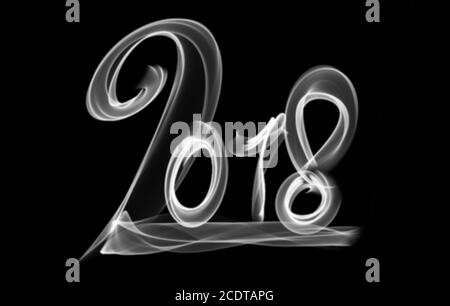 Happy new year 2018 isolated numbers lettering written with fire flame or smoke on black background Stock Photo