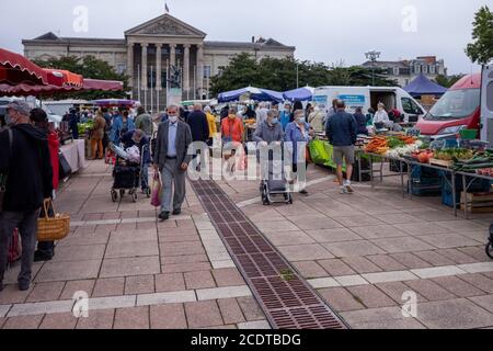 Angers, France - August 29 2020: people wearing face protective mask while shopping in the market place at France to prevent coronavirus, concept of wearing masks outdoor is mandatory, post-confinement mask mode in Europe Stock Photo