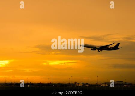 Airplane Takeoff in the evening Stock Photo