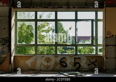 View through a window in an abandoned factory in Magdeburg in Germany Stock Photo