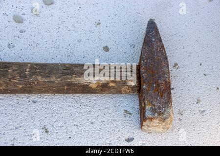A hammer on the white foamed concrete block Stock Photo