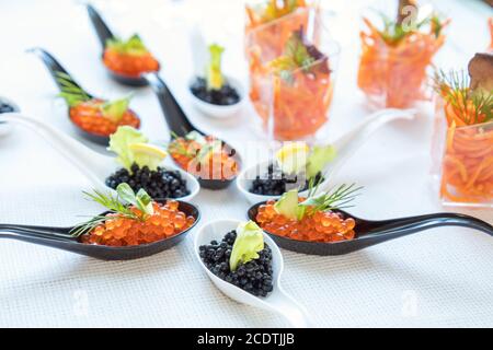 Beautifully decorated catering banquet table with different food salad, caviar on corporate christmas birthday party event or we Stock Photo