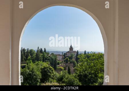 View of the bell tower of the Alhambra through the arched window from the Generalife gardens in Granada, Spain, Europe Stock Photo