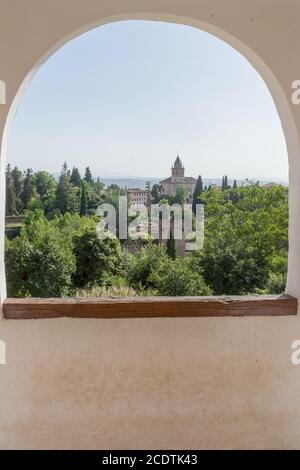 View of the bell tower of the Alhambra through the arched window from the Generalife gardens in Granada, Spain, Europe Stock Photo