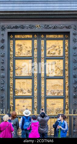 People at the Gates of Paradise at the Baptistery of St. John in Florence, Italy Stock Photo