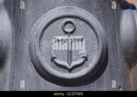 Icon of the sea anchor on the concrete. Symbol of seamen. Stock Photo