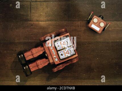 retro red robot has lost his head on a old wooden floor Stock Photo