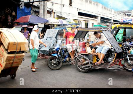 Road traffic in Manila, Philippines, with the typical tuk tuks Stock Photo