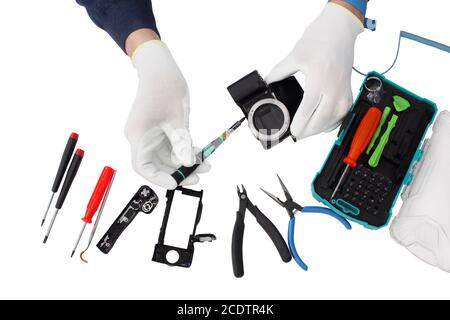 Repair of the modern  photo camera at professional service center. Stock Photo