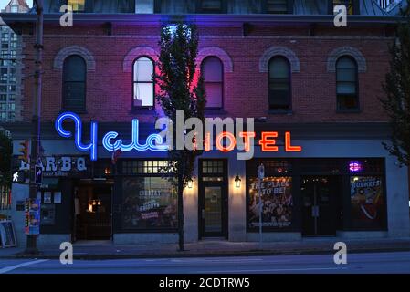 The neon sign for the Yale Hotel on Granville Street in downtown, Vancouver, British Columbia, Canada casts a blue, purple and red glow on the front o Stock Photo